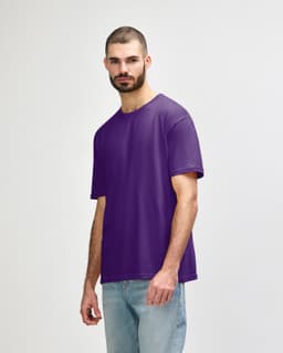 A purple Gildan Softstyle adult T-shirt displayed on a male model, with a simple design and a logo on the side.