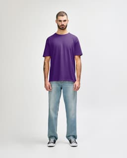A purple Gildan Softstyle adult t-shirt displayed on a mannequin paired with light blue jeans and white shoes.