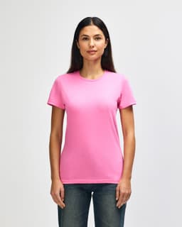 A pink Gildan Softstyle ladies' T-shirt on a model, featuring a classic crew neck and short sleeves.