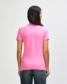 A pink Gildan Softstyle ladies' T-shirt is displayed from the back, featuring a fitted design and short sleeves.