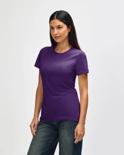 A Gildan Softstyle ladies' T-shirt in purple, featured on a model, displayed from the side with casual jeans.