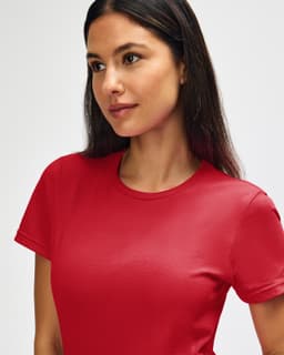 A red Gildan Softstyle ladies' t-shirt displayed on a model with a plain background. It features a logo on the shirt.