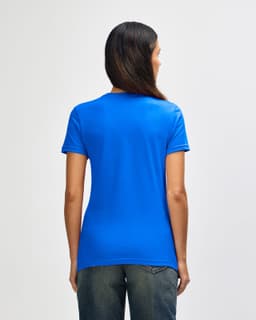 A blue ladies' t-shirt with a fitted design and a subtle brand logo on the back, paired with denim jeans.