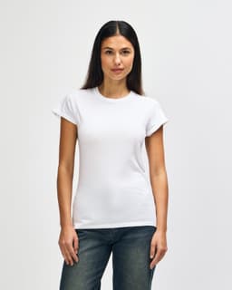 A white Gildan Softstyle ladies' t-shirt displayed on a model, featuring a simple design and short sleeves.