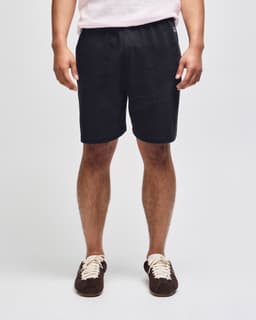 Cotton gym shorts in dark grey, featuring an elastic waistband and a logo on the side. Suitable for sports activities.