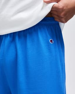 Bright blue cotton gym shorts with an elastic waistband and logo detail on the side.