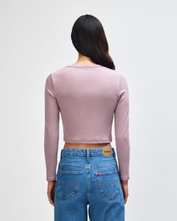 A fitted long-sleeve crop t-shirt in muted pink, featuring a simple design and a back view.