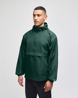 A model wearing a green packable anorak jacket with a hood, featuring a front pocket and a logo.