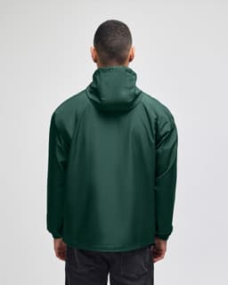 A green packable anorak jacket with a hood, viewed from the back. The jacket has a logo on the back.