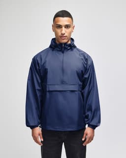 A navy packable anorak jacket with a hood and front pocket, featuring a logo on the chest.