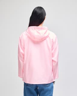 A pink packable anorak jacket featuring a hood, viewed from the back, with a logo on the sleeve.