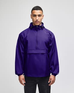 A purple packable anorak jacket with a front pocket and a hood, featuring a logo.