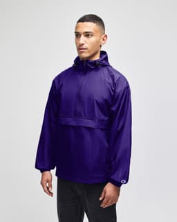 A purple packable anorak jacket with a hood and a front pocket, featuring a logo on the sleeve.