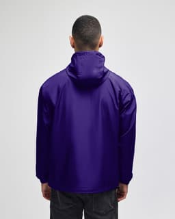A packable anorak jacket in a vibrant purple colour, featuring a hood and a branding logo on the back.