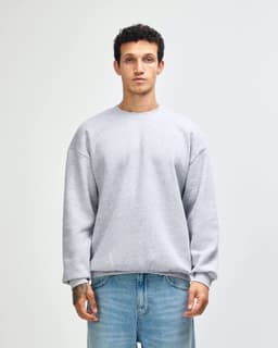 A unisex crewneck sweatshirt in light grey, featuring long sleeves and a comfortable fit. It has a branding logo.