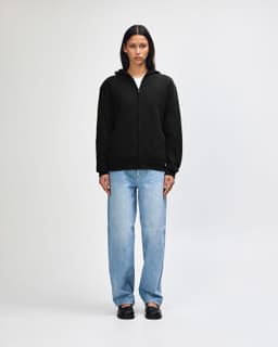 A black unisex hooded sweat with a full zip, featuring a simple design and a back view of the model.