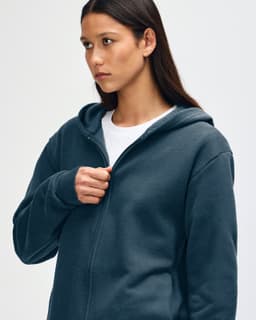 A navy unisex full zip hooded sweatshirt with a relaxed fit and a logo on the front.