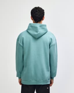 A unisex hooded sweatshirt in a soft green colour, featuring a spacious hood and a relaxed fit.