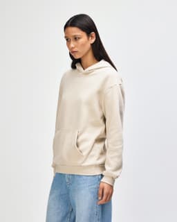 A unisex hooded sweatshirt in beige featuring a front pocket and a logo on the chest.