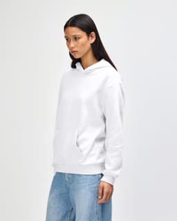 A unisex hooded sweatshirt in white, featuring a front pouch pocket and a logo on the side.