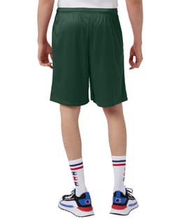 Green mesh shorts with pockets, featuring a logo, view from the back. Styled with white socks and sneakers.