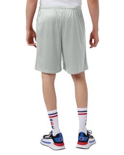 A pair of light grey sports shorts with pockets, featuring a logo, viewed from behind.