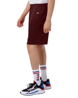 Maroon mesh shorts with pockets, featuring a logo, displayed on a person wearing sporty shoes and socks.