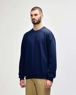 A navy blue Gildan Softstyle adult sweatshirt with a crew neck and long sleeves, featuring a logo.