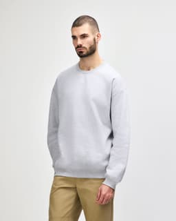 A grey Gildan Softstyle adult sweatshirt displayed on a mannequin, featuring a crew neck and long sleeves.