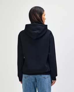 A black hooded sweatshirt with a relaxed fit, featuring a hood and a kangaroo pocket. It has a logo on the back.