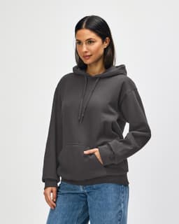 A hooded sweatshirt in olive green, featuring a front pocket and a drawstring hood. The model is wearing blue jeans.