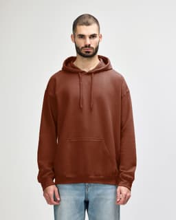 A brown Gildan Softstyle adult hooded sweatshirt worn by a woman, featuring a front pocket and drawstring hood.