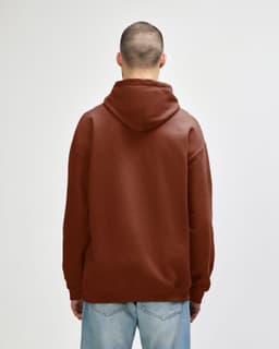 A brown hooded sweatshirt featuring a spacious hood and a relaxed fit, with an unseen logo on the back.
