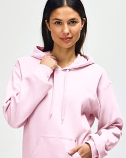 A pink hooded sweatshirt featuring a front pocket and a hood. The product has a logo on it.