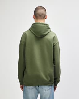 A green Gildan Softstyle adult hooded sweatshirt viewed from the back, featuring a hood and long sleeves.