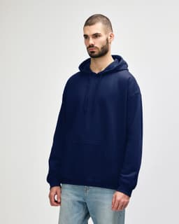 A navy Gildan Softstyle adult hooded sweatshirt featuring a front pocket and a logo. Worn by a model in casual attire.