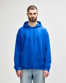 A blue Gildan Softstyle adult hooded sweatshirt on a model, featuring a front pouch pocket and drawstring hood.