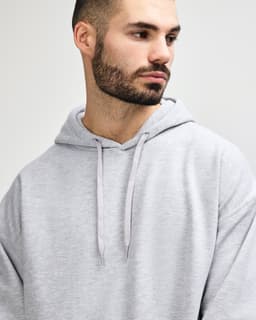 A grey Gildan Softstyle adult hooded sweatshirt featuring a drawstring hood and a simple design without visible branding.