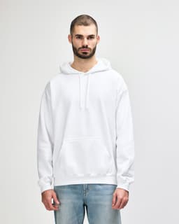 A white Gildan Softstyle adult hooded sweatshirt is worn by a model posing with one hand on her hip.