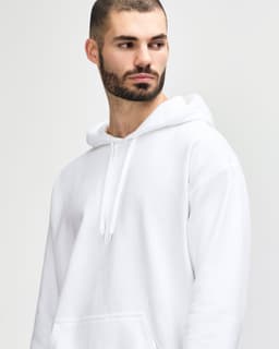 A white Gildan Softstyle adult hooded sweatshirt with a front pocket and a drawstring hood, modelled by a man.