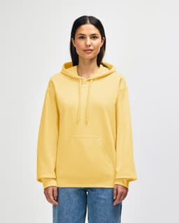 A yellow Gildan Softstyle adult hooded sweatshirt displayed on a model, featuring a front pocket and a logo.