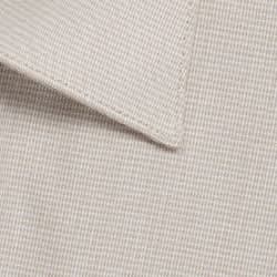 A close-up of a button-up shirt featuring a light beige puppytooth pattern with a collar.