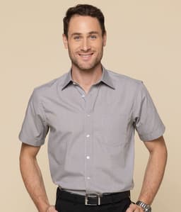 A short-sleeved grey button-up shirt with a pocket and a logo on the chest worn by a smiling man.