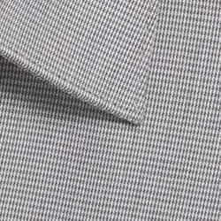 A close-up of a button-up shirt featuring a grey puppytooth pattern and a pointed collar. It has a logo.