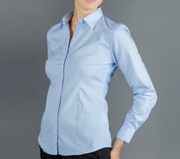 A light blue button-up shirt with a fitted design and a branding logo. Features a classic collar and long sleeves.