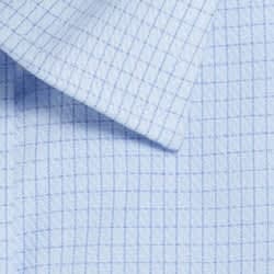A close-up of a light blue button-up shirt fabric featuring a check pattern with a crisp collar.
