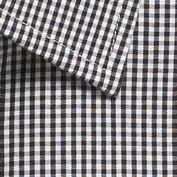 A close-up of a black and white gingham patterned button-up shirt collar with a logo present.