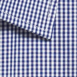 A close-up of a blue and white gingham fabric, featuring a button-up shirt collar with a checkered pattern.