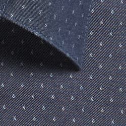A close-up of a dark chambray fabric featuring a subtle pattern of small, light-coloured dots.