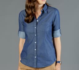 A blue button-up shirt featuring a chambray design with rolled sleeves and a subtle dotted pattern.